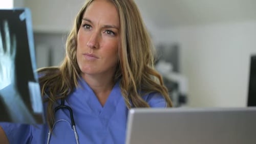 Doctor Checking X-ray in Clinic