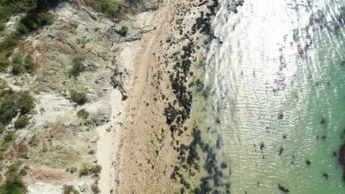 Aerial shot of a empty beach with clear water, shot on a bright sunny day.