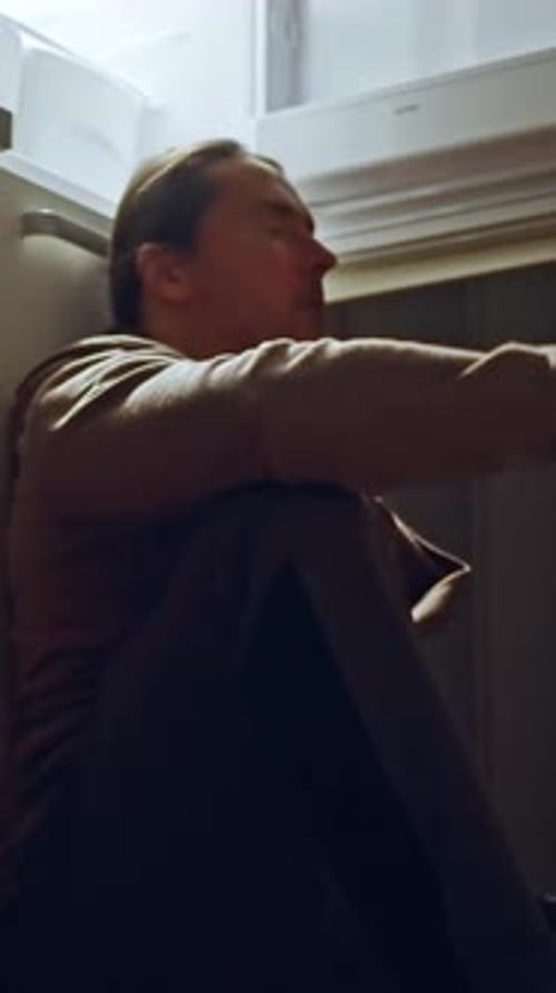 Man Sits Next to an Open Refrigerator on the Kitchen Floor in a Frustrated State A Reflective Moment