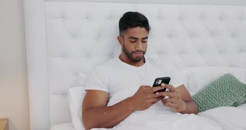 Man, phone and sad in bedroom with message, reading or texting with depression for post on social