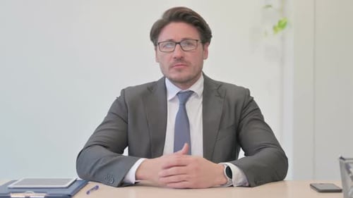 Middle Aged Businessman Looking Around for Opportunity in Office