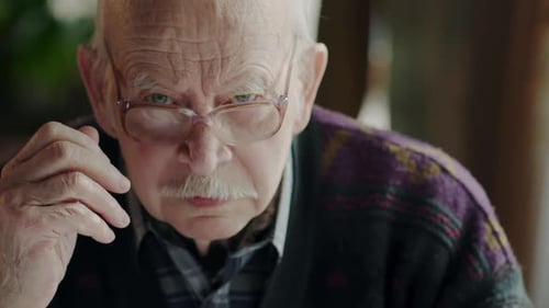 Senior Man Smiling After Removing Glasses