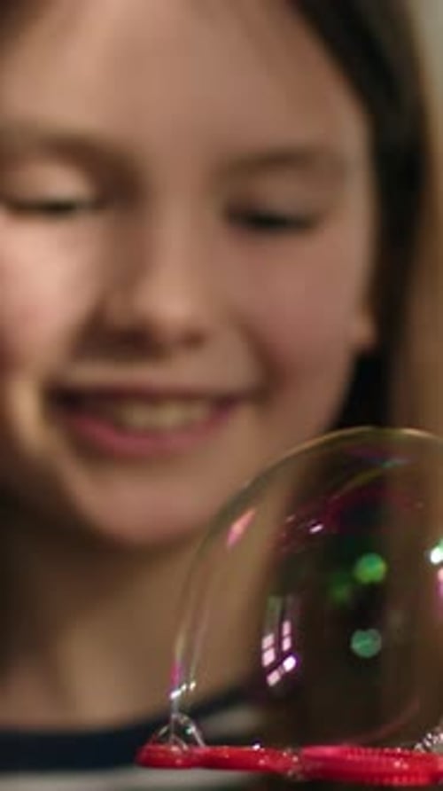 Portrait Caucasian Little Girl Child Kid Holding Soap Bubbles on Plastic Stick Playing Smiling Happy