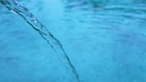 Pure Water Pouring into a Refreshing Blue Pool