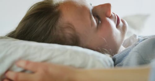 Woman Waking Up and Smiling in Morning Light