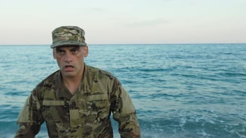Soldier in Uniform Screams on the Beach