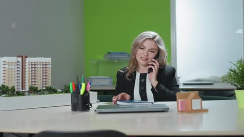 Marketer Multitasks Taking Customer Order in Modern Office