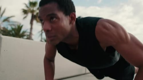 Man Exercising Outdoors Doing Pushups at Beach