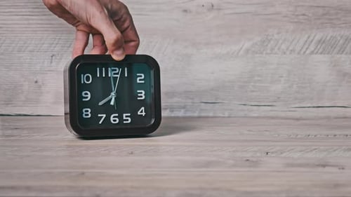 Clock is Placed on Wooden Surface