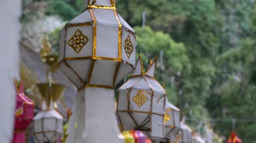 Panning down shallow focus on lots of Colourful Hanging Lanterns in Temple Festival, Thailand