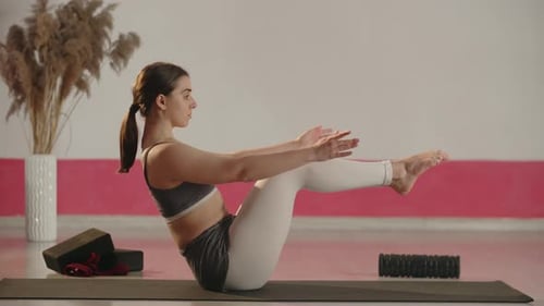 Fitness Girl Doing Balance Exercise on the Sport Mat Side View of Young Woman Stretching During Home