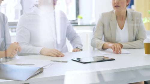 Colleagues Meeting at Office Table with Tablet