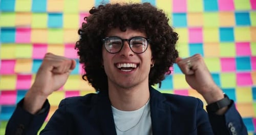 Young Man Cheering in an Office Setting