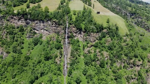 Remote Waterfall Flowing from a Cliffside in the Green Austrian Countryside