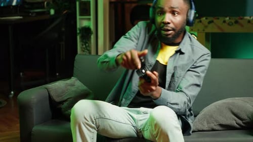 Young Adult Playing Video Game at Home