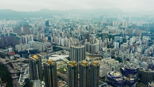 Aerial View of Hong Kong's Urban Landscape with Modern Skyscrapers and Mountains