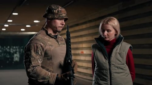 Man with Rifle Beside a Woman in a Tunnel