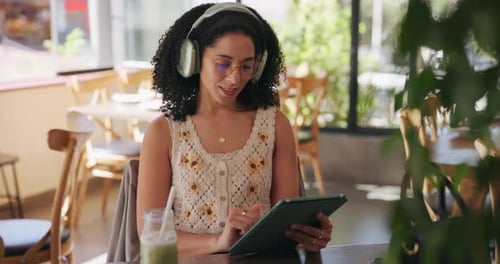 Remote work, headphones and woman with tablet in cafe for freelance job