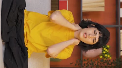 Young Woman Experiencing Neck Pain Lying Down