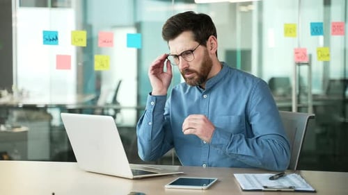 Stressed Man Working at Office Desk
