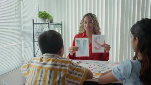 Speech Therapist Asking Kids to Repeat Letters Pronunciation at Class