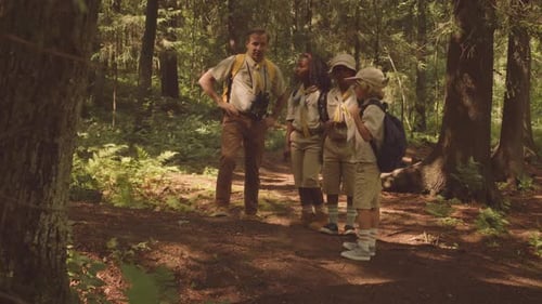 Scouter Showing Diverse Kids Around Forest