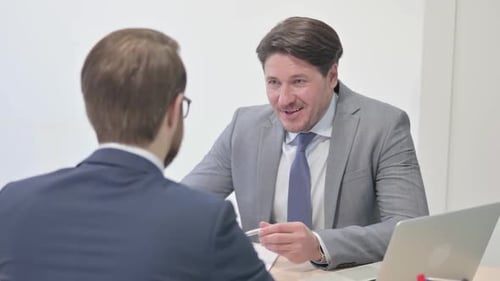 Businessmen Having a Discussion in a Corporate Office