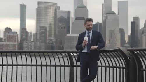 Stylish Man with Coffee Standing in a City