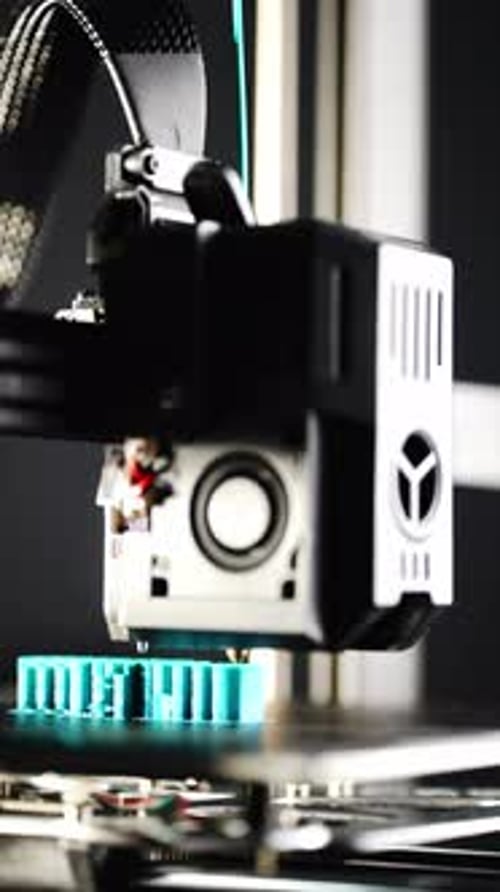 3D Printer Constructing a Turquoise Geometric Structure