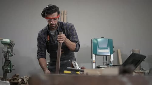 Carpenter is working at workshop.