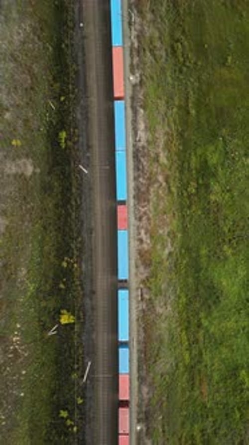 Cargo Train Transporting Freight Through Rural Area