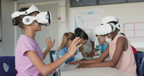 Using VR headsets, students exploring virtual reality in school classroom