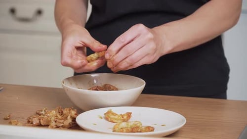 Woman Peeling and Preparing Shrimp in a Kitchen