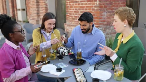 Friends Enjoying Sushi Outdoors