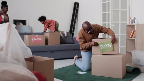 Father Sticking Toys Sign on Cardboard Box