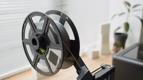 Close up of Gray Filament Mounted on 3D Printer