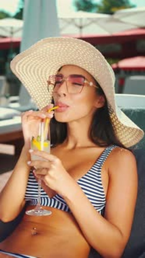 Woman Sipping Cocktail on Tropical Beach Getaway