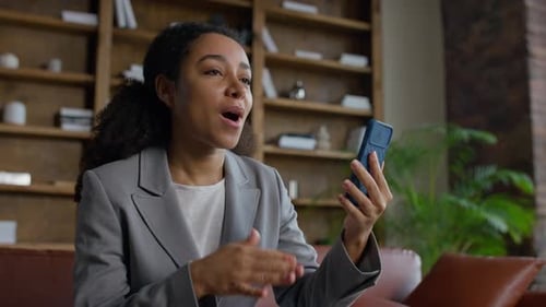 Young Woman Video Calling with Phone Indoors