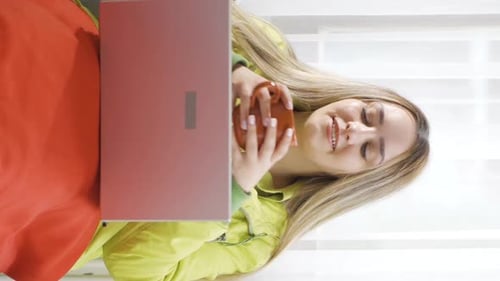 Woman Relaxes with Laptop and Coffee at Home