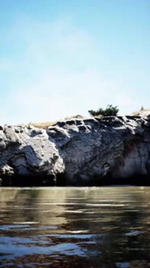 Vertical Video of Large Rock Island in the Middle of the Sea Water