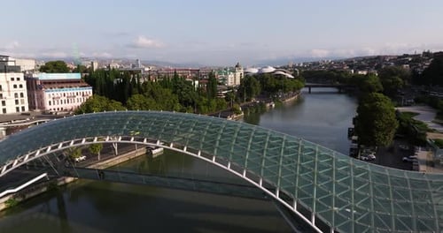 Beautiful Drone Shot Above Modern Bridge in Tbilisi, Georgia. Cinematic