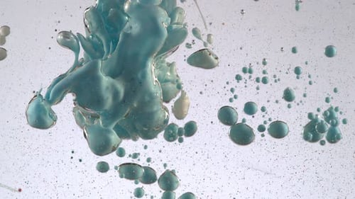 Abstract footage of colorful paint mixing in water