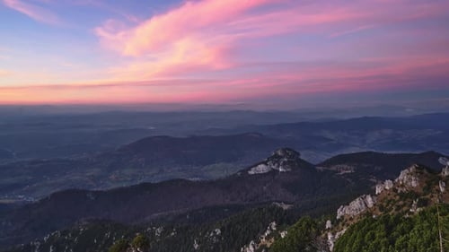 Warm Colors of Clouds at Dusk in a Rocky Forest Mountain Landscape