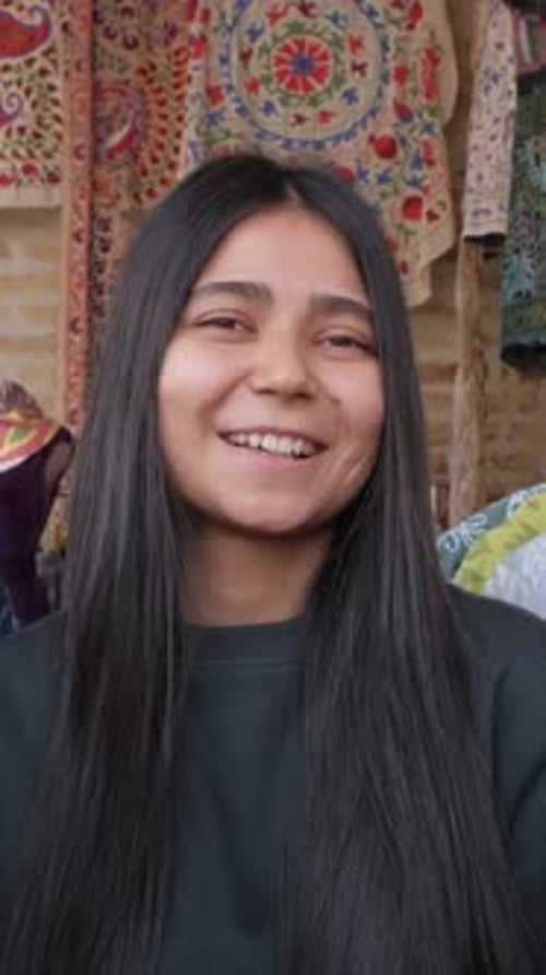 Smiling Woman with Long Hair in Colorful Setting