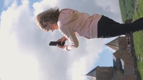 Girl Taking Photos Over Georgian Church