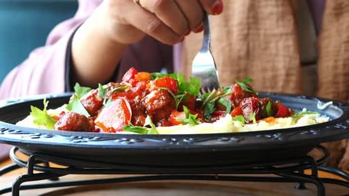 Woman Hand Fork Pick Turkey Meatballs on a Plate