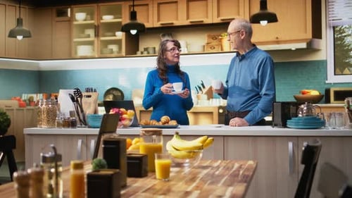 Senior Couple Enjoying Coffee Together in Sunny Kitchen