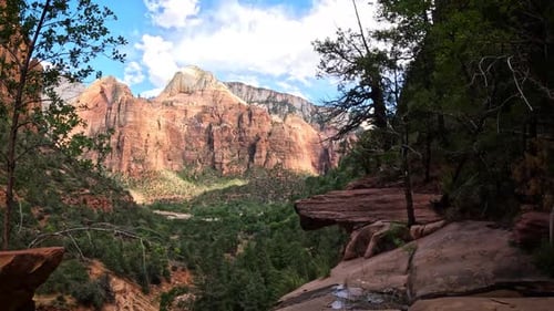 Clouds move over mountains time lapse