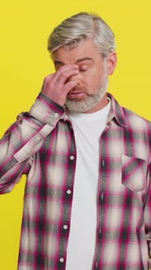 Mature Man Talking and Rubbing his Eyes