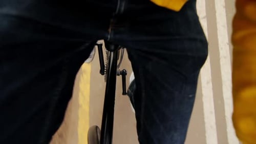 Road Cyclist Standing Up And Pushing On Pedals. Guy In Jeans Riding Bike Standing Up. Lifestyle C...